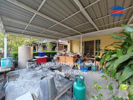 Outdoor kitchen space with various cooking utensils and storage items