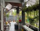 Spacious covered porch area with seating and lush greenery