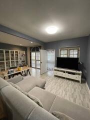 Spacious living room with built-in bookshelves and large windows