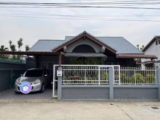 Frontal view of a residential house with car parking