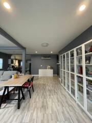 Spacious and modern living room with gray walls and ample shelving