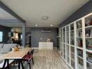 Spacious and modern living room with gray walls and ample shelving