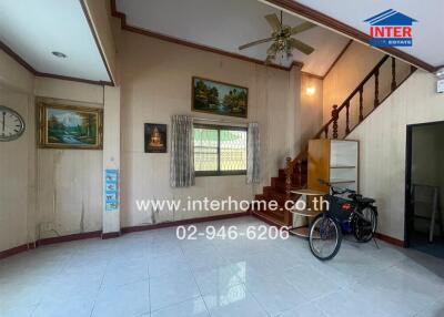 Spacious living room with staircase and natural light