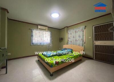 Spacious bedroom with large bed, ample lighting, and integrated kitchen area