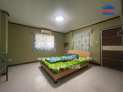 Spacious bedroom with large bed, ample lighting, and integrated kitchen area