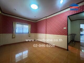Spacious living room with red patterned wallpaper and wooden wainscoting