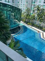 Luxurious apartment complex pool with surrounding greenery and modern design features