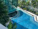 Luxurious apartment complex pool with surrounding greenery and modern design features