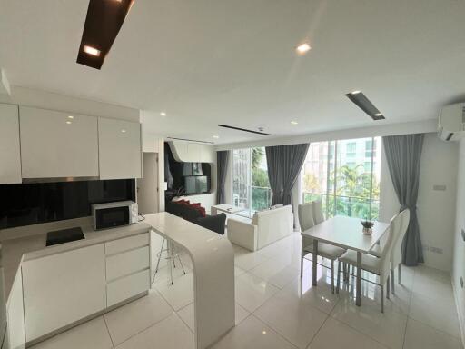 Spacious modern living room with dining area and kitchenette