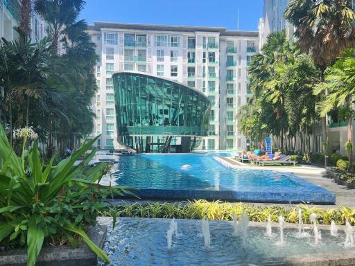 Luxurious residential building with modern architectural design and a large swimming pool