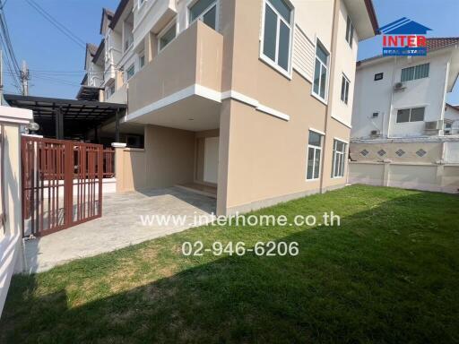 Modern two-story house with spacious lawn and parking area