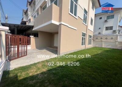 Modern two-story house with spacious lawn and parking area