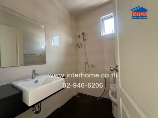 Modern bathroom with white walls and natural light