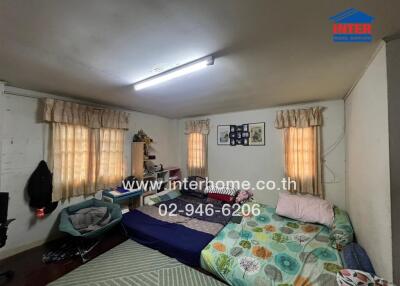 Spacious bedroom with double bed and ample natural lighting