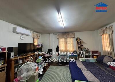 Spacious and furnished bedroom with natural lighting