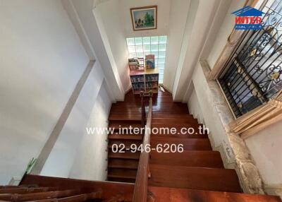 Elegant wooden staircase in a well-lit home interior with decorative elements