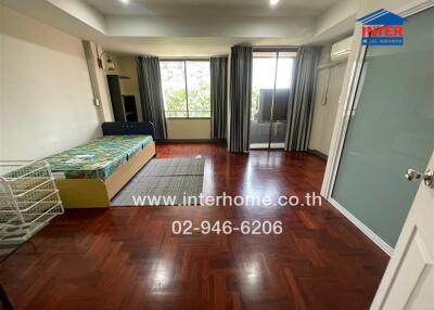 Spacious bedroom with natural light and balcony access