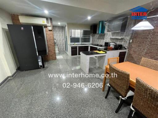 Modern kitchen with dining area in a well-lit space