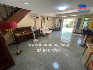 Spacious living room with piano and glossy tiled flooring