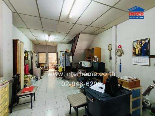 Spacious living room with various personal items and furniture