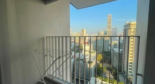 Urban balcony with a panoramic city view and clothes drying rack