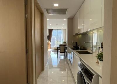 Modern kitchen with hallway leading to bright dining area