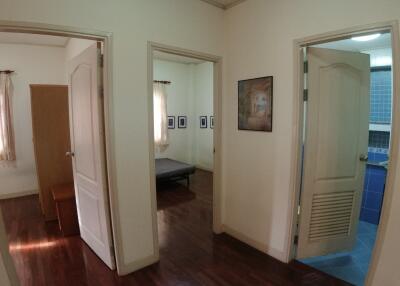 Spacious hallway with multiple doorways leading to different rooms including a bedroom and bathroom