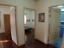Spacious hallway with multiple doorways leading to different rooms including a bedroom and bathroom
