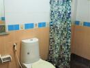 Compact bathroom with colorful tile accents and basic amenities