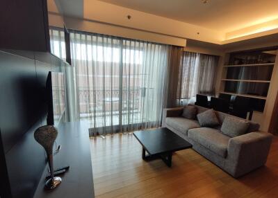 Elegant living room with gray sofa, modern furnishings and large windows