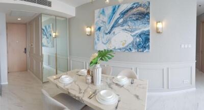 Elegant dining area with marble table and modern art