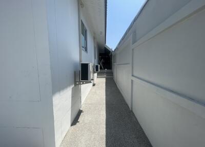 Narrow pathway leading to house entrance