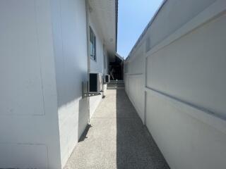 Narrow pathway leading to house entrance