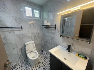 Modern bathroom with marble tiles and stylish fixtures