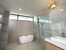 Modern bathroom with freestanding tub and glass shower