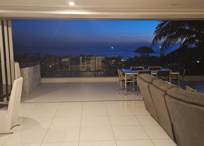 Spacious living room with ocean view at dusk