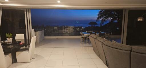 Spacious living room with ocean view at dusk