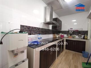 Modern kitchen with stainless steel appliances and dark cabinetry