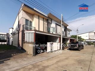 Modern two-story house with carport and balcony in a residential area