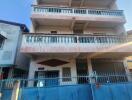 multi-story residential building with blue balconies