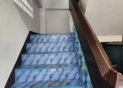 Interior view of a staircase with blue patterned tiles