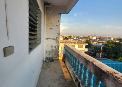 View of a balcony overlooking a cityscape during sunset