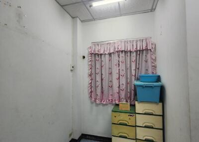 Narrow hallway with decorative ceiling and storage units