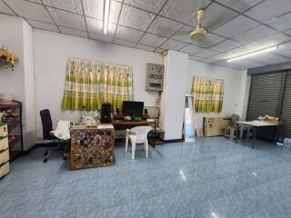 Spacious office space with tiled flooring and organized workstations