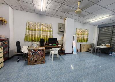Spacious office space with tiled flooring and organized workstations