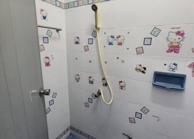 Bright bathroom with decorated tiles and blue floor