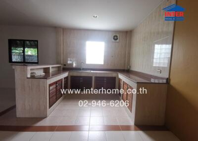 Spacious modern kitchen with built-in cabinets and tiled floors