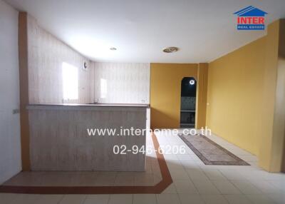 Spacious living room with bar counter and entry to hallway