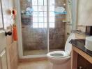 Spacious bathroom with shower, natural light, and modern amenities