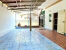 Spacious covered patio area with tiled flooring and ample natural light